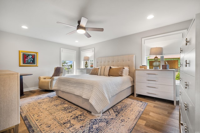 bedroom with wood finished floors, ceiling fan, recessed lighting, and baseboards