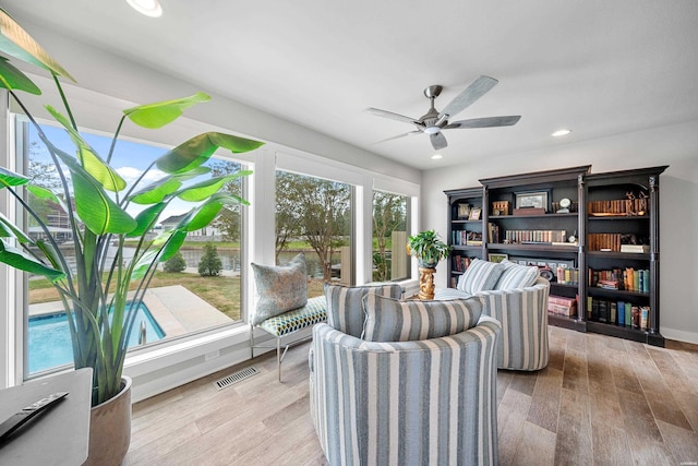 sitting room with recessed lighting, a ceiling fan, visible vents, and wood finished floors