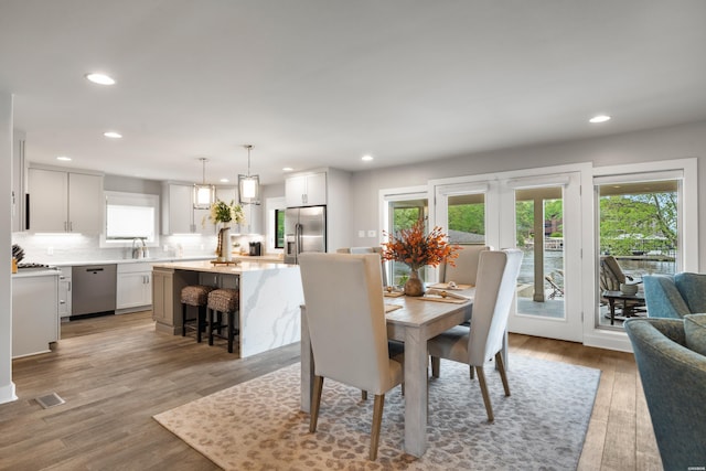 dining area featuring visible vents, recessed lighting, and light wood finished floors
