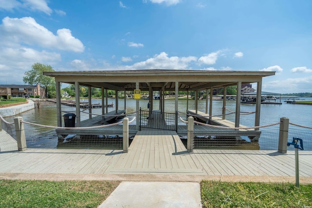 dock area with boat lift and a water view