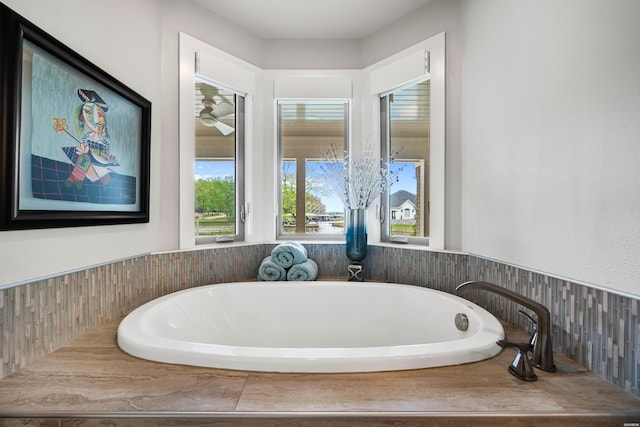 bathroom featuring a bathtub and a wealth of natural light