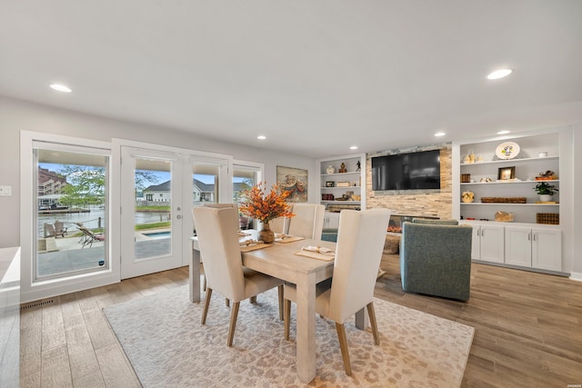 dining space with visible vents, french doors, recessed lighting, and light wood-style flooring