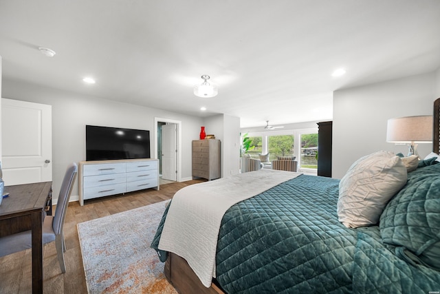 bedroom with wood finished floors, recessed lighting, and baseboards