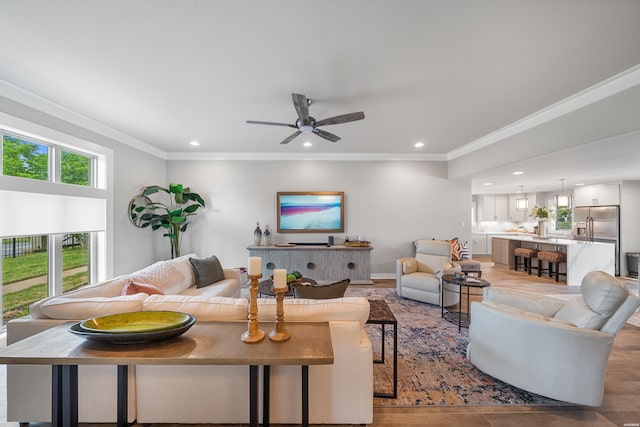 living area with crown molding, recessed lighting, a ceiling fan, and wood finished floors