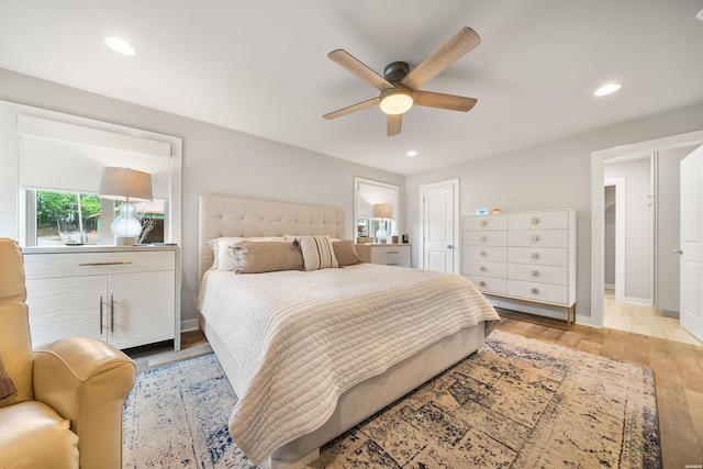 bedroom featuring baseboards, recessed lighting, a ceiling fan, and light wood finished floors