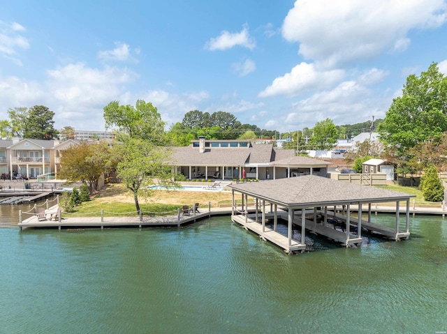 dock area with a water view and boat lift
