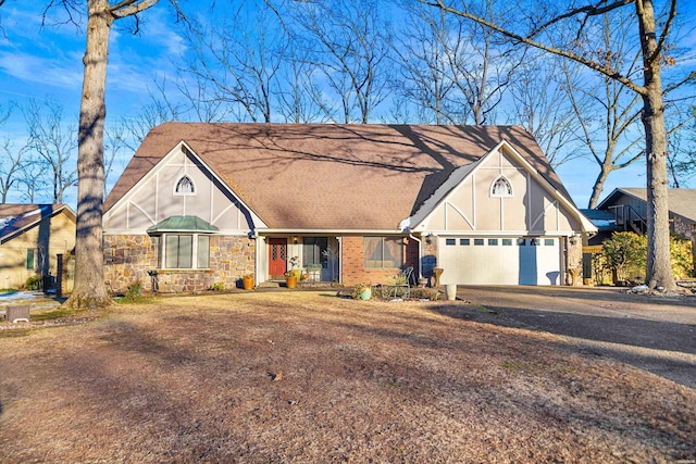 english style home with a garage, stone siding, roof with shingles, and driveway