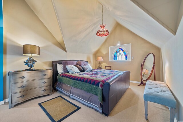 bedroom with lofted ceiling, baseboards, and light colored carpet