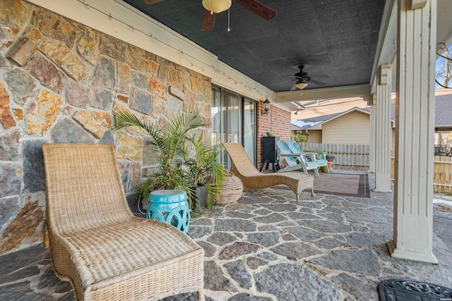 view of patio / terrace featuring ceiling fan and fence