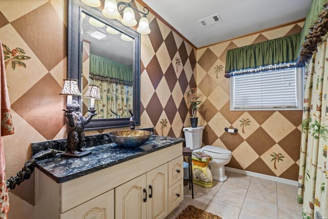 bathroom with toilet, vanity, visible vents, and tile patterned floors