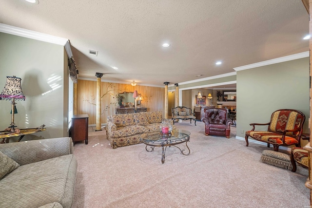 carpeted living area featuring baseboards, a textured ceiling, visible vents, and crown molding