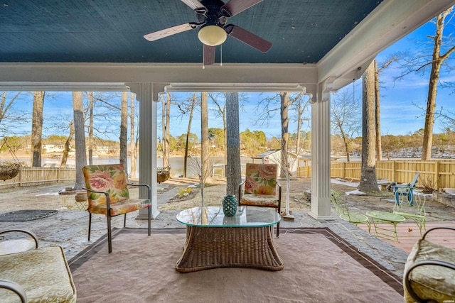 unfurnished sunroom featuring a ceiling fan