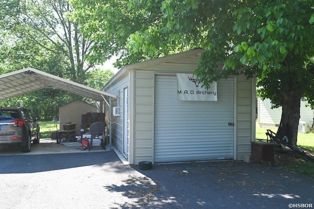 142 Taylor Loop, Oden, AR 71961 - garage with a detached carport and driveway