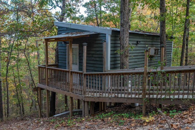 exterior space featuring a deck and metal roof