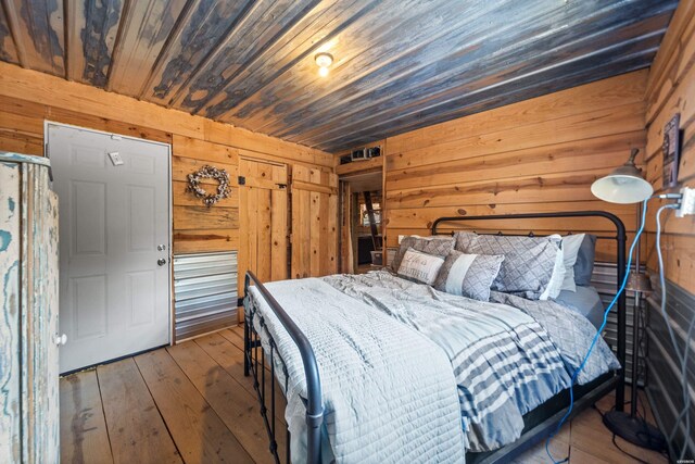 unfurnished bedroom featuring wooden ceiling, wood walls, and wood finished floors