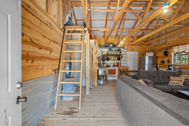 living area with wood walls and wood finished floors