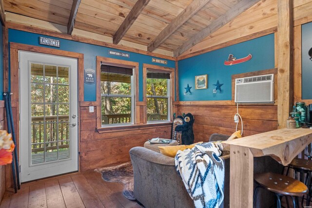 interior space featuring vaulted ceiling with beams, wooden ceiling, wood walls, wainscoting, and a wall mounted air conditioner