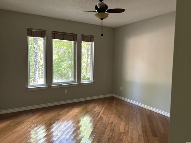 1 Telon Way, Hot Springs Village, AR 71909 - spare room featuring healthy amount of natural light, hardwood / wood-style flooring, baseboards, ceiling fan, and a textured ceiling