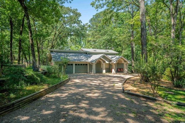 view of front of house featuring gravel driveway and an attached garage