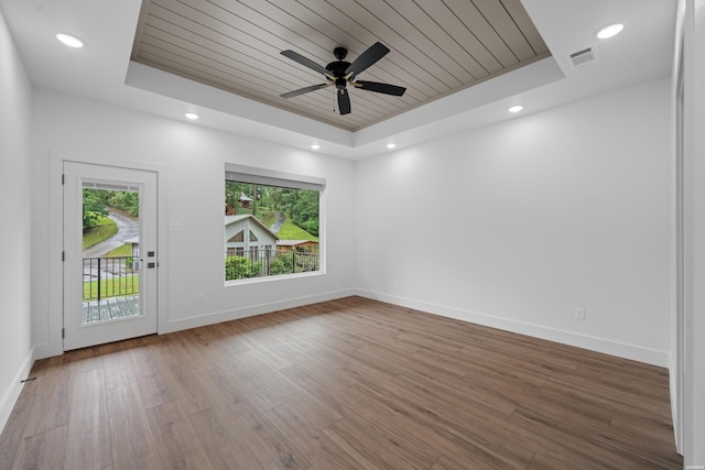 168 Krause Ln Unit A & B, Hot Springs, AR 71913 - empty room with a tray ceiling, healthy amount of natural light, wood ceiling, wood finished floors, and baseboards
