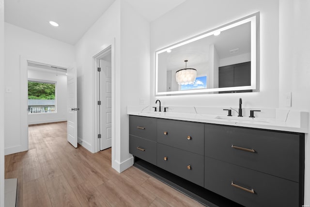 168 Krause Ln Unit A & B, Hot Springs, AR 71913 - bathroom with wood finished floors, double vanity, a chandelier, and baseboards