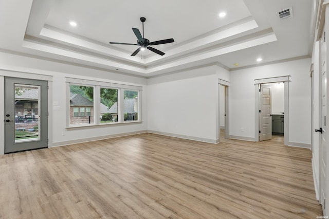 211 Cromwell Ct, Hot Springs, AR 71901 - unfurnished living room featuring a tray ceiling, light wood-style flooring, plenty of natural light, and recessed lighting