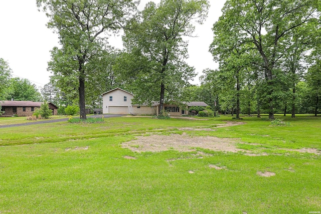 4413 Front Dr, Bryant, AR 72022 - view of yard featuring aphalt driveway and a garage
