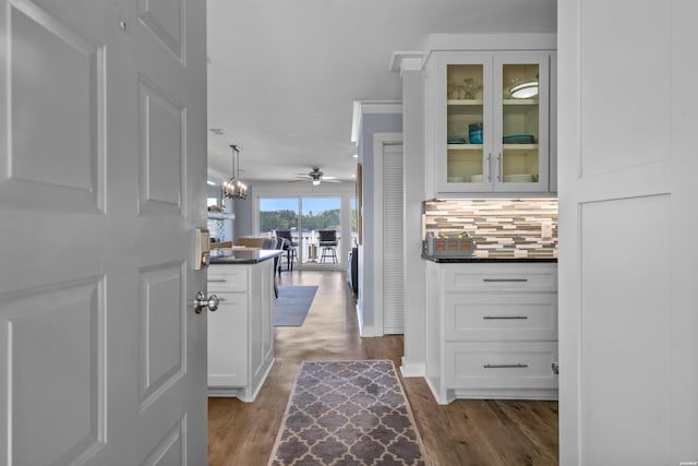 interior space with a notable chandelier and dark wood-style flooring