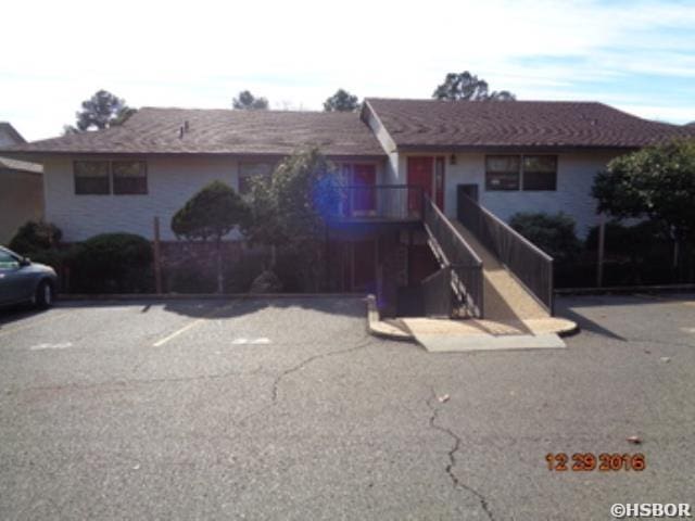 single story home with stairs and uncovered parking