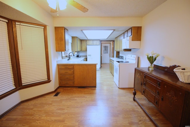 1 Alora Ln, Hot Springs Village, AR 71909 - kitchen with light countertops, white appliances, brown cabinetry, and light wood-style flooring