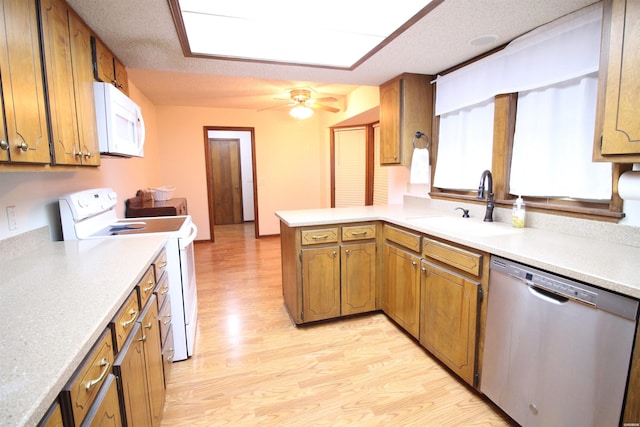 1 Alora Ln, Hot Springs Village, AR 71909 - kitchen featuring brown cabinetry, white appliances, light countertops, and a peninsula