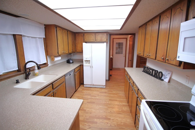 1 Alora Ln, Hot Springs Village, AR 71909 - kitchen featuring light countertops, white appliances, brown cabinetry, and a sink
