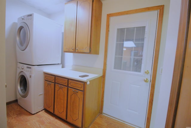 1 Alora Ln, Hot Springs Village, AR 71909 - washroom with cabinet space, light wood-style flooring, and stacked washing maching and dryer