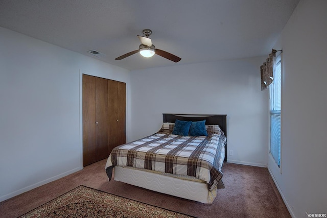 bedroom with baseboards, carpet, visible vents, and a closet