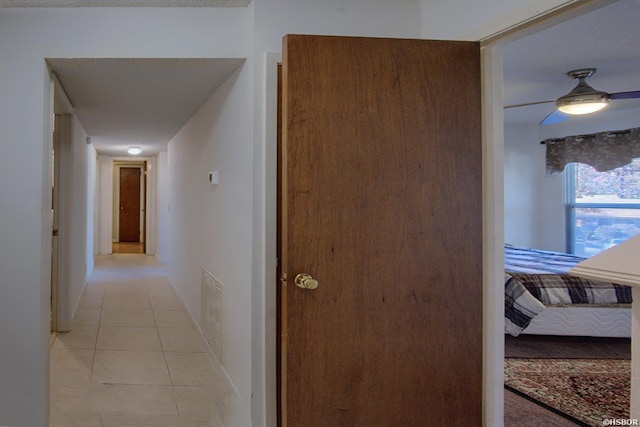 hall with visible vents and light tile patterned flooring