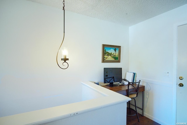 office space with dark wood-type flooring and a textured ceiling