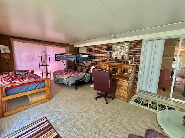 bedroom featuring brick wall, visible vents, and carpet flooring