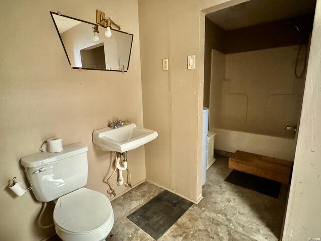bathroom with a sink, unfinished concrete flooring, and toilet