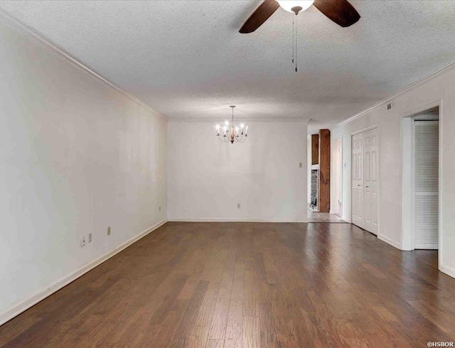 empty room featuring dark wood-style floors, ornamental molding, a textured ceiling, baseboards, and ceiling fan with notable chandelier