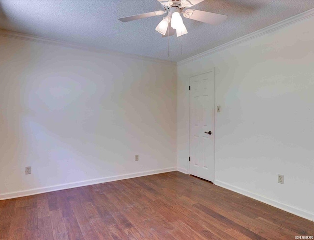 spare room with crown molding, dark wood-type flooring, a ceiling fan, a textured ceiling, and baseboards