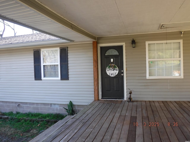 doorway to property with a shingled roof and crawl space