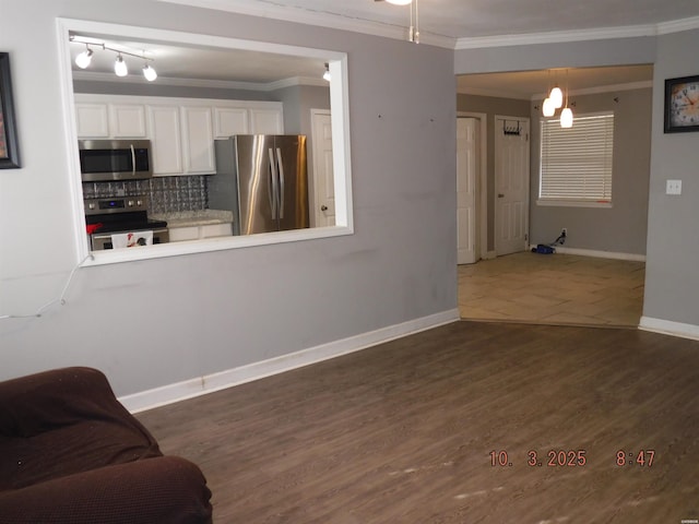 living room featuring baseboards, dark wood finished floors, and ornamental molding