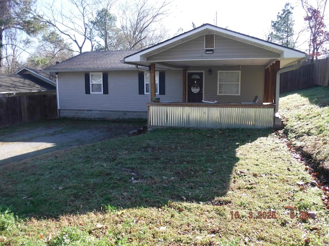 view of front of home with a porch, a front lawn, and fence