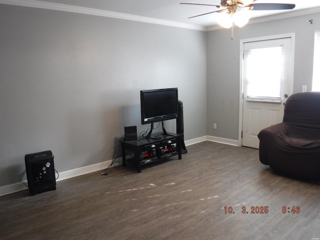 sitting room with ceiling fan, baseboards, wood finished floors, and ornamental molding