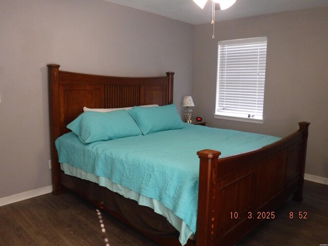 bedroom with baseboards and wood finished floors