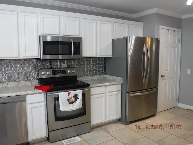 kitchen featuring visible vents, ornamental molding, tasteful backsplash, white cabinetry, and stainless steel appliances