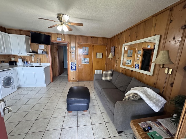 210 Aberina St Unit E4, Hot Springs, AR 71913 - living area with light tile patterned flooring, ceiling fan, a textured ceiling, wood walls, and washer / clothes dryer