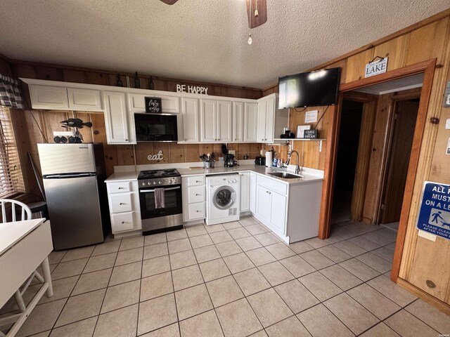 210 Aberina St Unit E4, Hot Springs, AR 71913 - kitchen with washer / clothes dryer, wood walls, a sink, light countertops, and stainless steel appliances