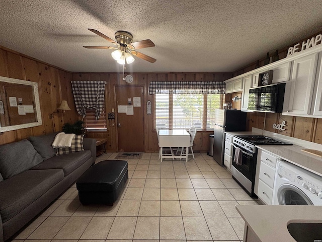 210 Aberina St Unit E4, Hot Springs, AR 71913 - kitchen with washer / dryer, white cabinets, stainless steel appliances, and wood walls