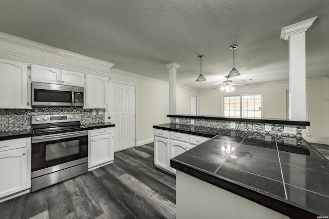 221 San Juan Dr, Hot Springs, AR 71913 - kitchen featuring stainless steel appliances, decorative columns, crown molding, a ceiling fan, and backsplash